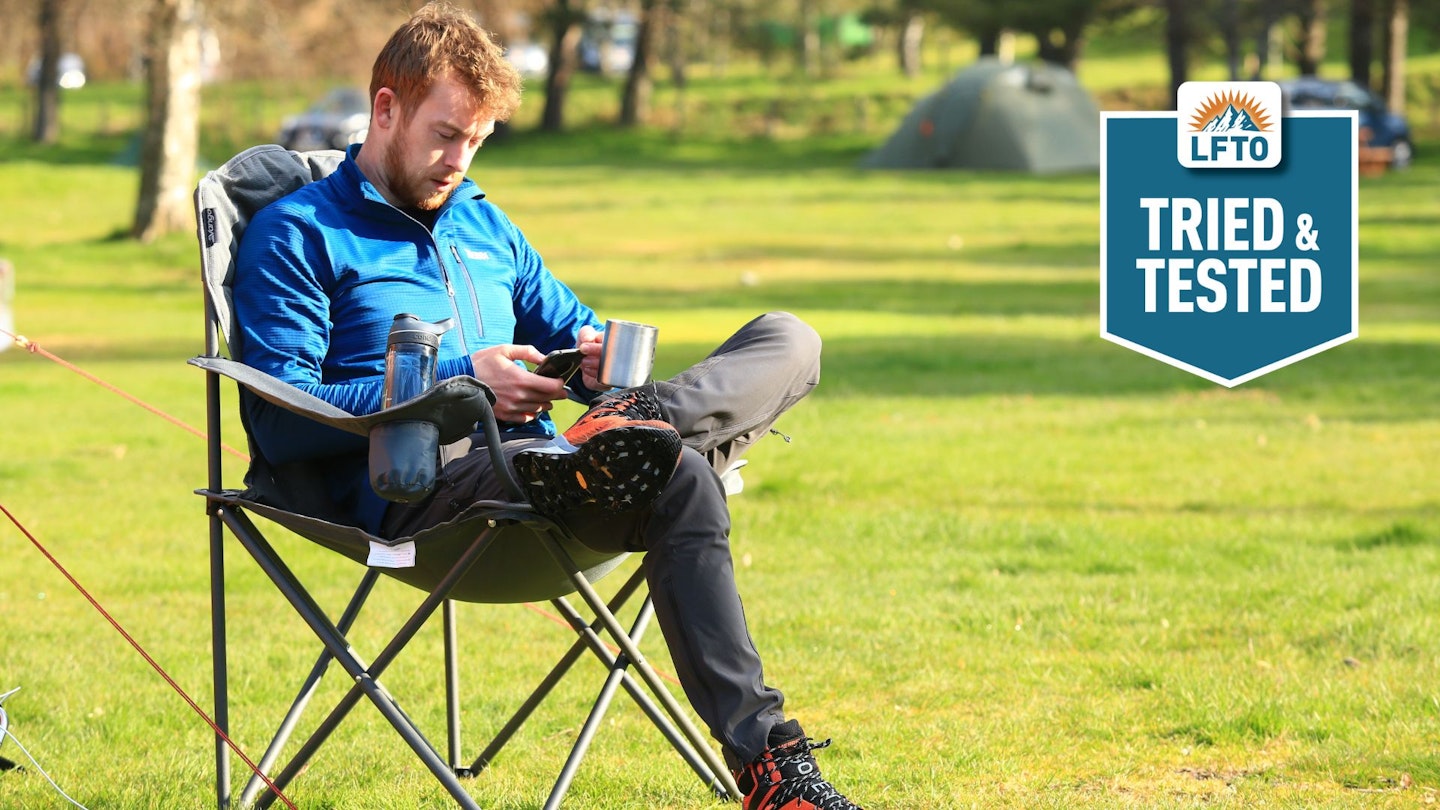 LFTO tester sitting in a camping chair with a mug of coffee