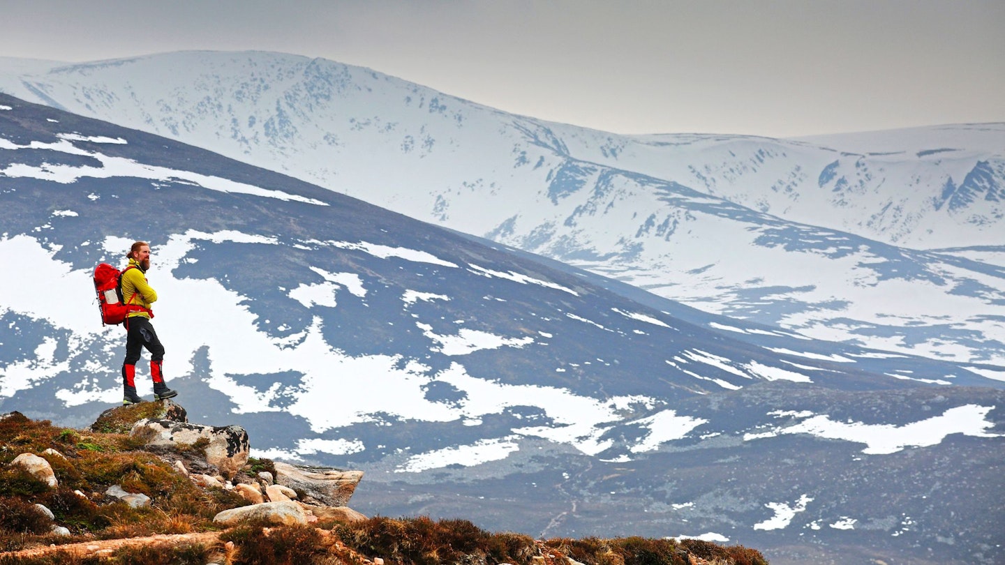 Man on a rocky outcrop in the Cairngorms.