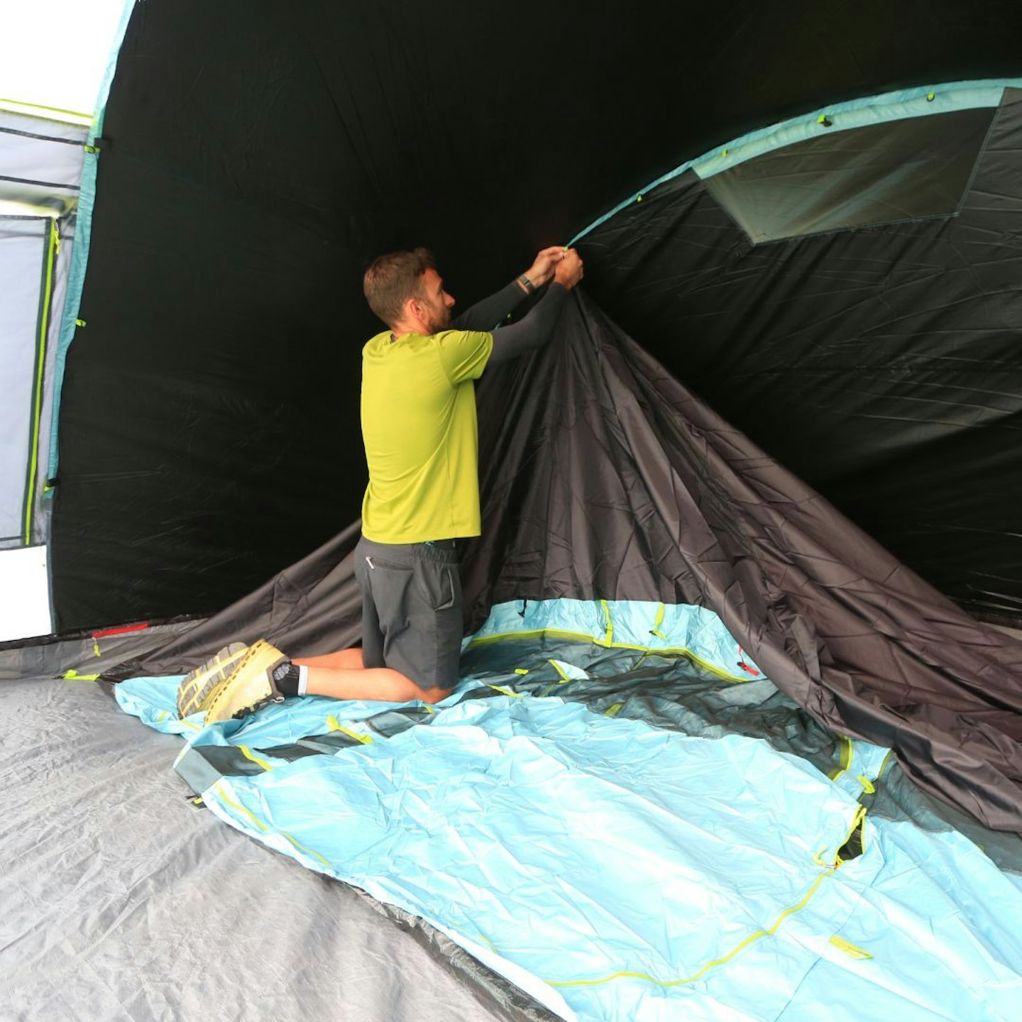 Person putting up Coleman Meadowood 6L BlackOut Tent bedroom inner