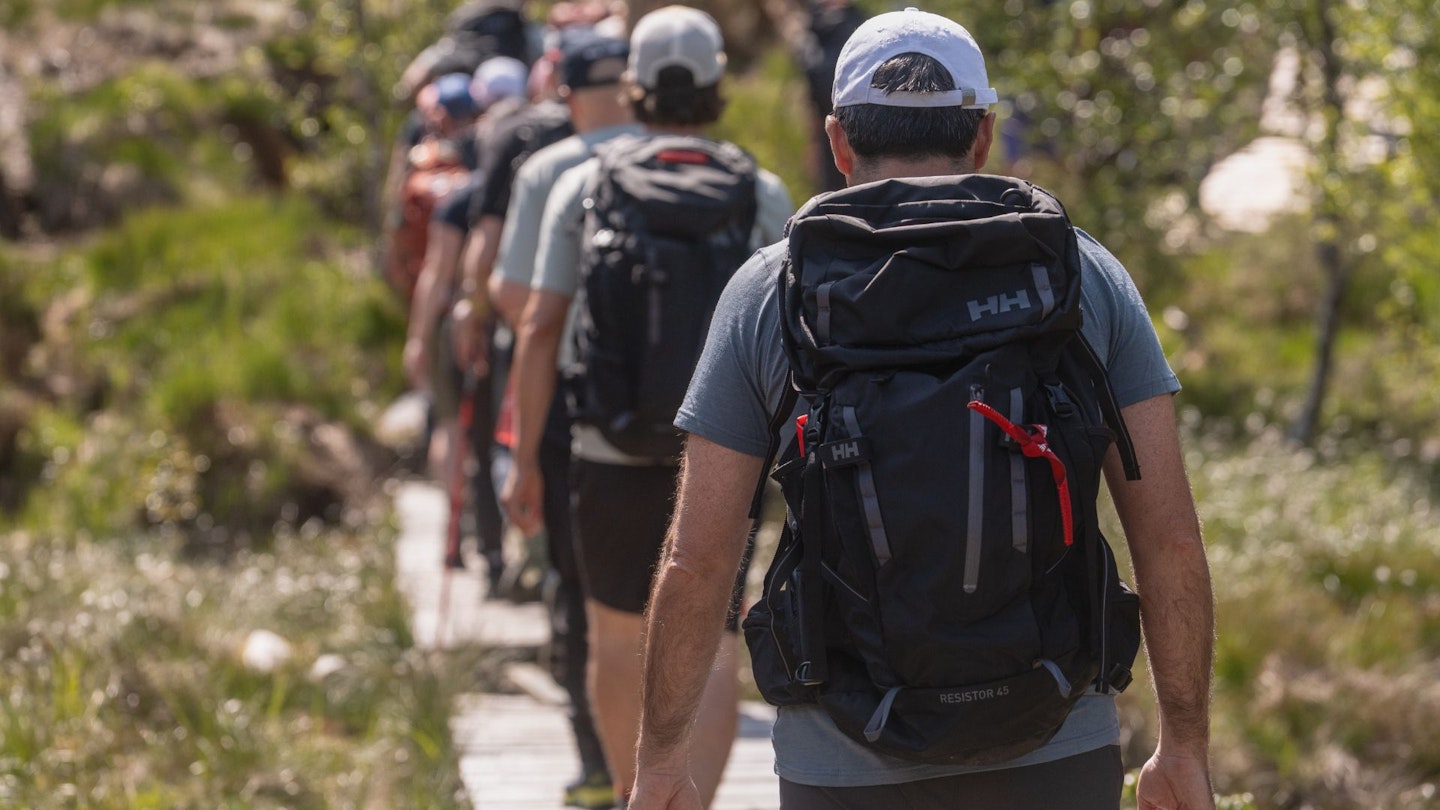 Man testing the Helly Hansen 45L Resistor Backpack Recco