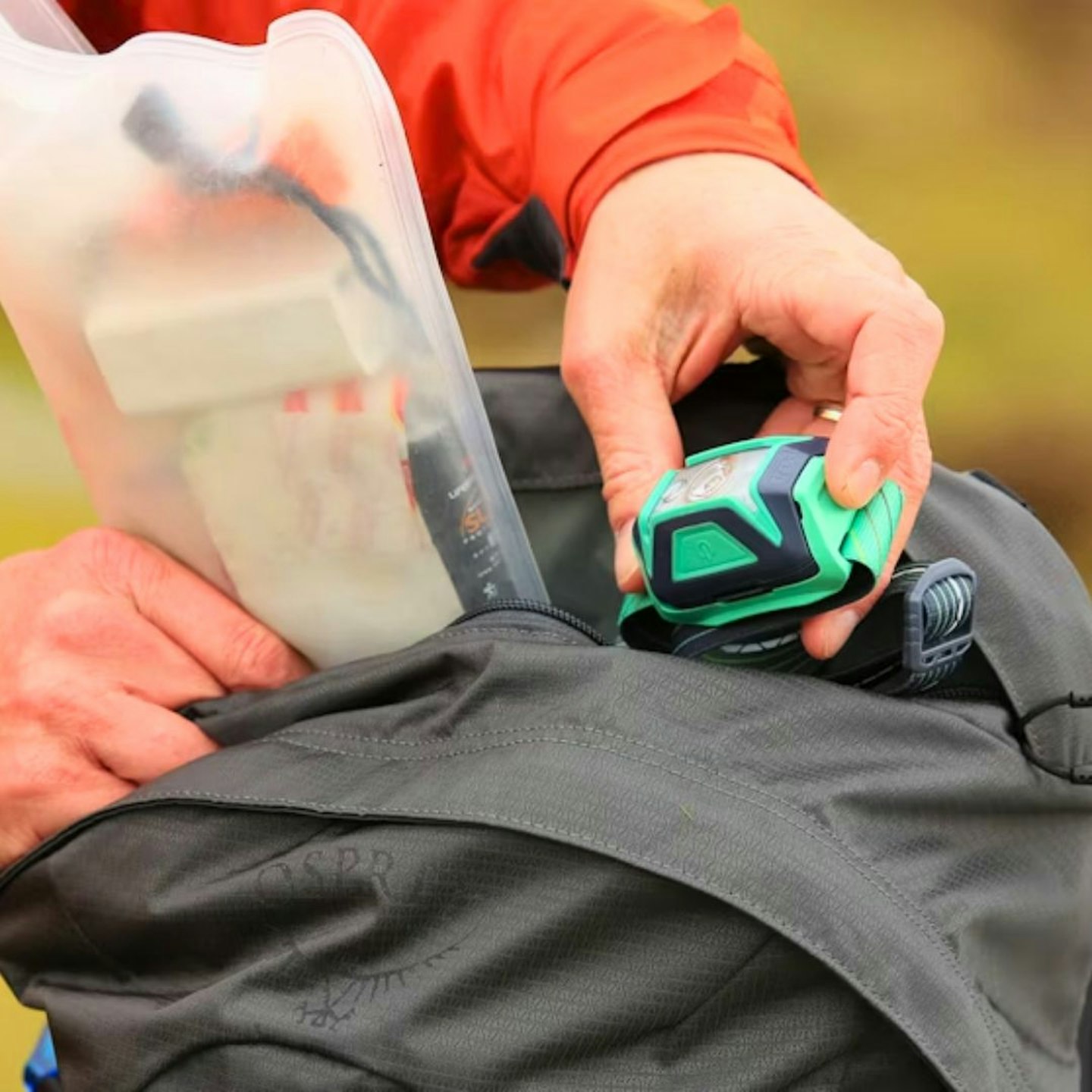 LFTO tester putting items in Osprey Talon 22 top pocket